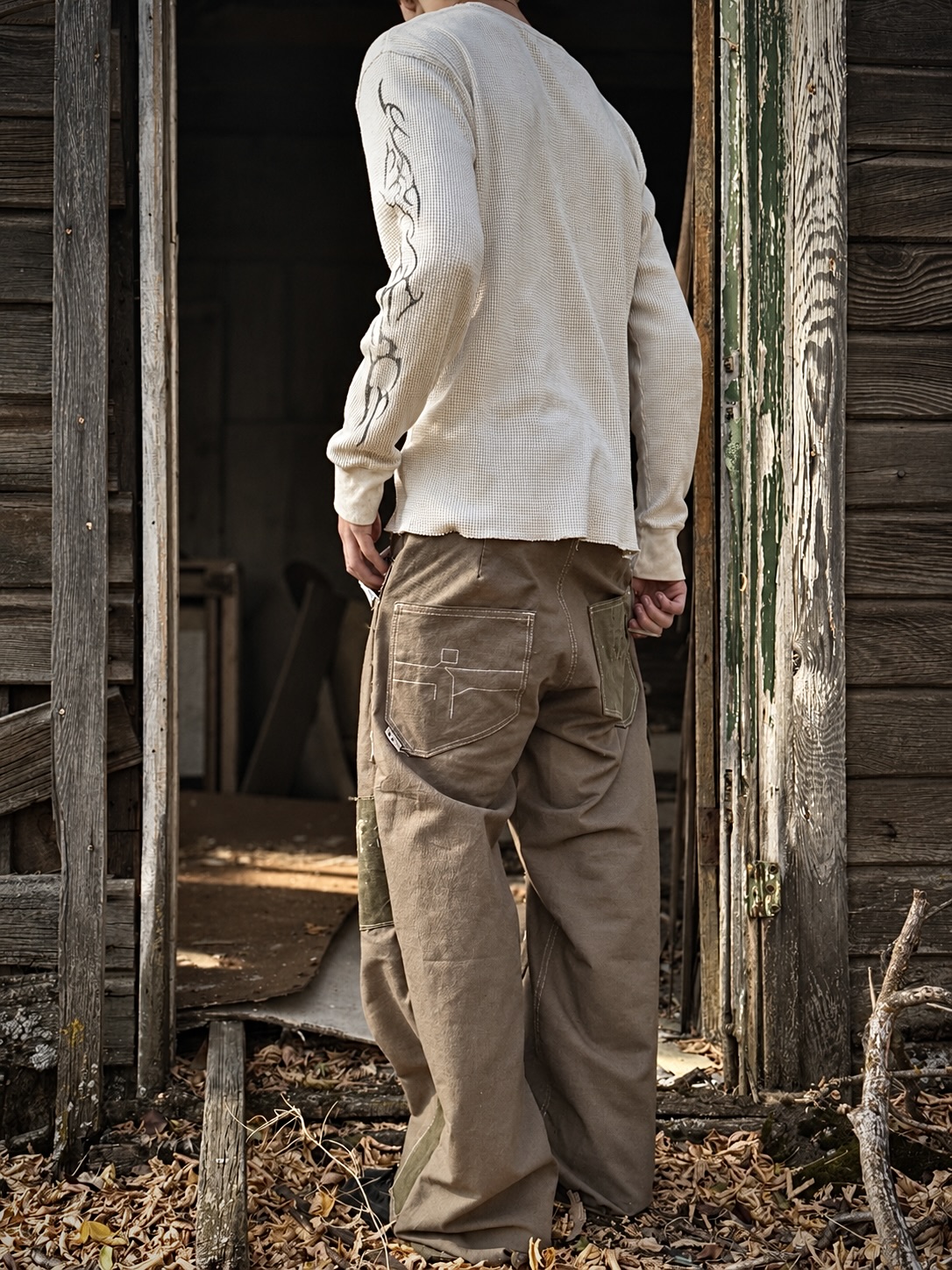 Field / Green — rear view against a weathered wooden building